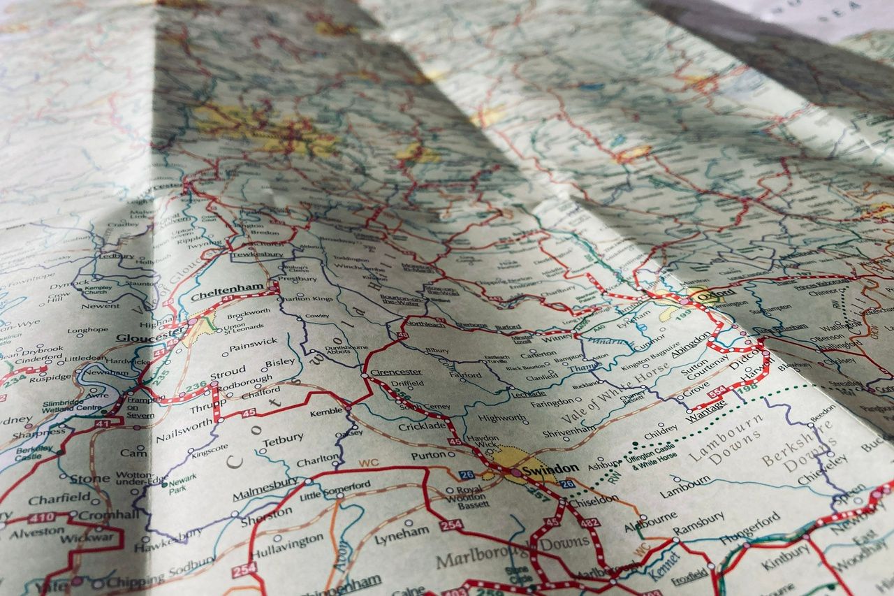 A map spread out on the table with Swindon marked at the bottom of the photo and the rest out of focus.